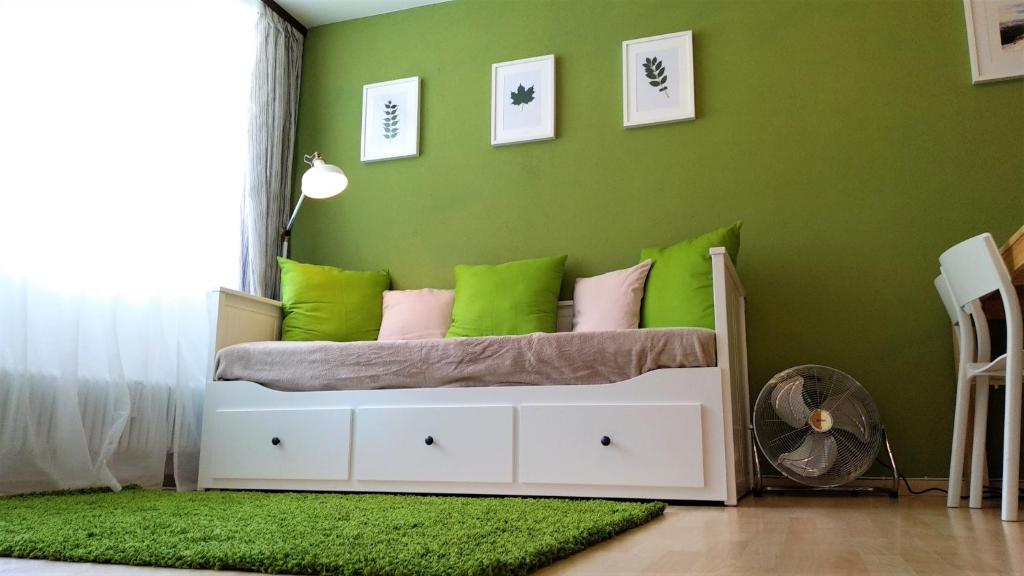a green bedroom with a bed with green walls at Green Wall Apartment Kaprun in Kaprun