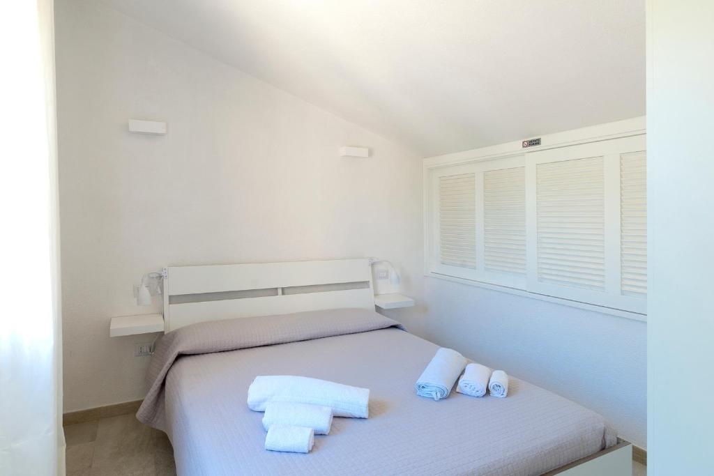 a bedroom with a bed with towels on it at Dimora Simius in Villasimius
