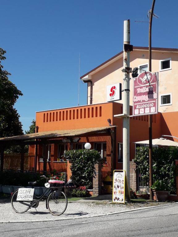 a bike parked on the street in front of a building at La Campagnola Trattoria con Alloggio in Misano Adriatico