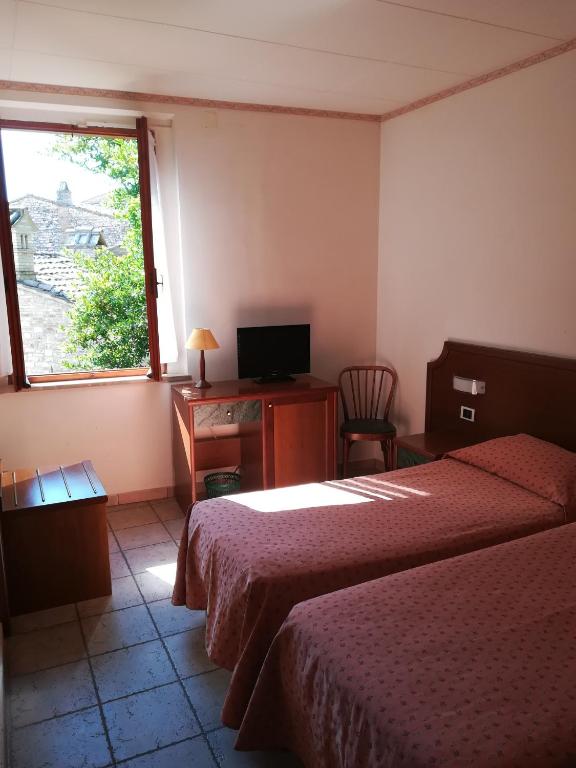 Postel nebo postele na pokoji v ubytování Hotel San Pietro