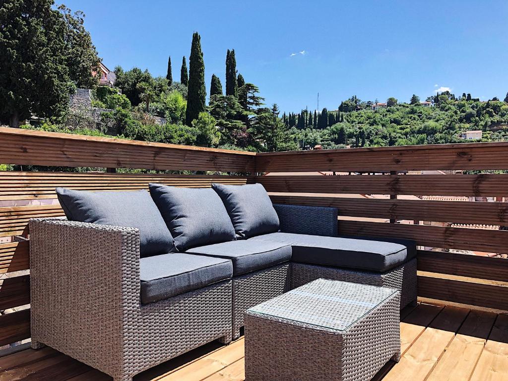 a patio with a couch on a wooden deck at Altana Mario in Piran