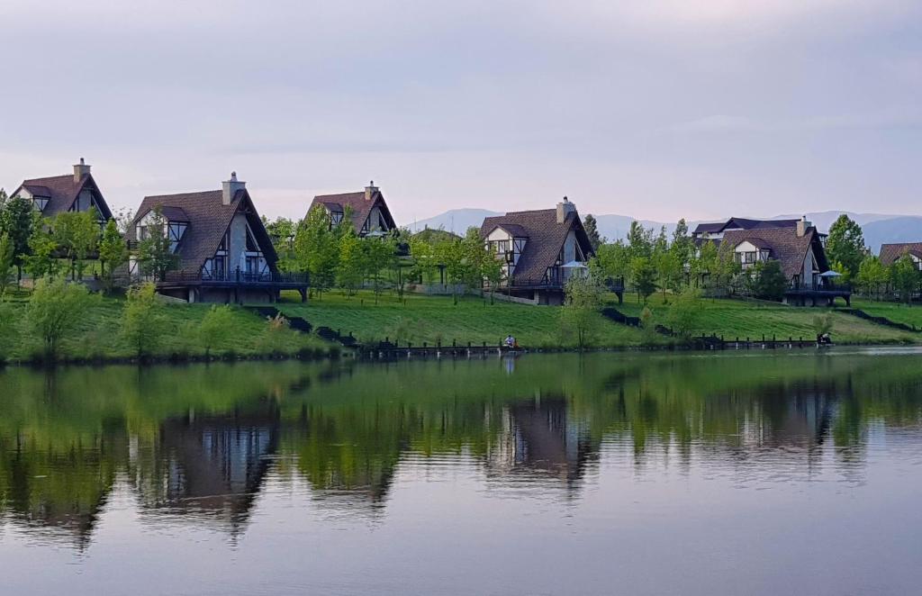 a group of houses on the shore of a lake at Sakit Gol - Silent Lake Hotel in Shamakhi