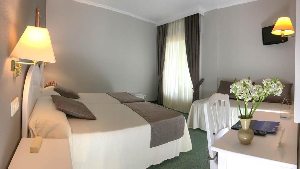 A bed or beds in a room at Hotel Spa Bosque mar