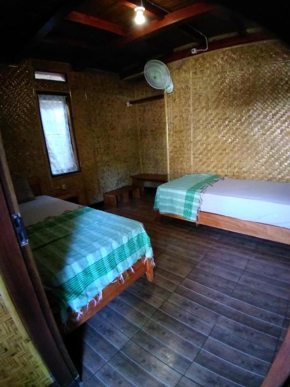 Postel nebo postele na pokoji v ubytování Lima Bintang