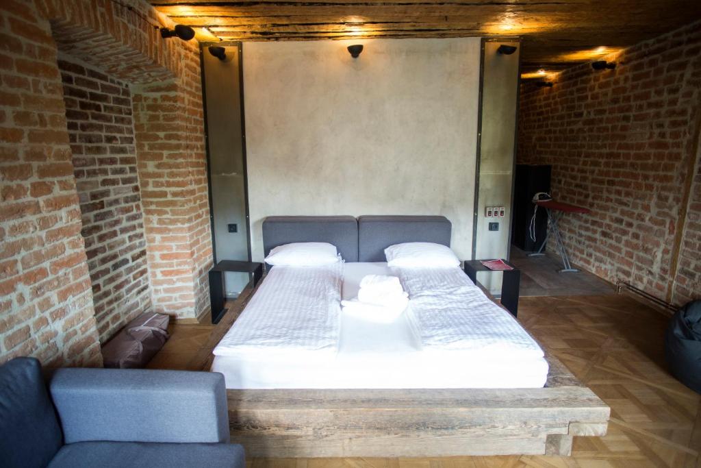 a room with a bed in a brick wall at Vysoka Khata2 in Lviv