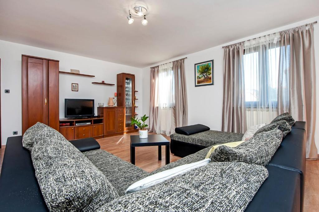 a living room with a couch and a tv at Apartment Nika in Rovinj