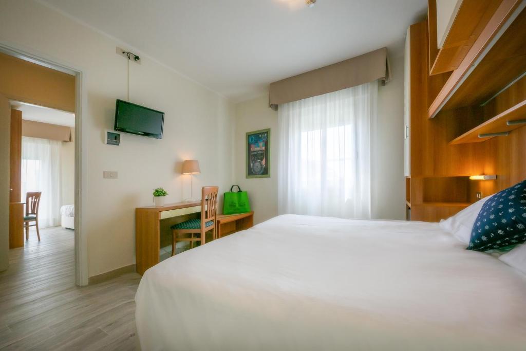 Postel nebo postele na pokoji v ubytování Hotel Verona