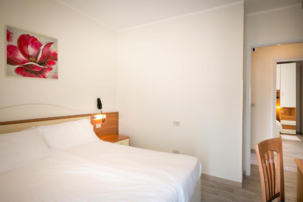Postel nebo postele na pokoji v ubytování Hotel Verona