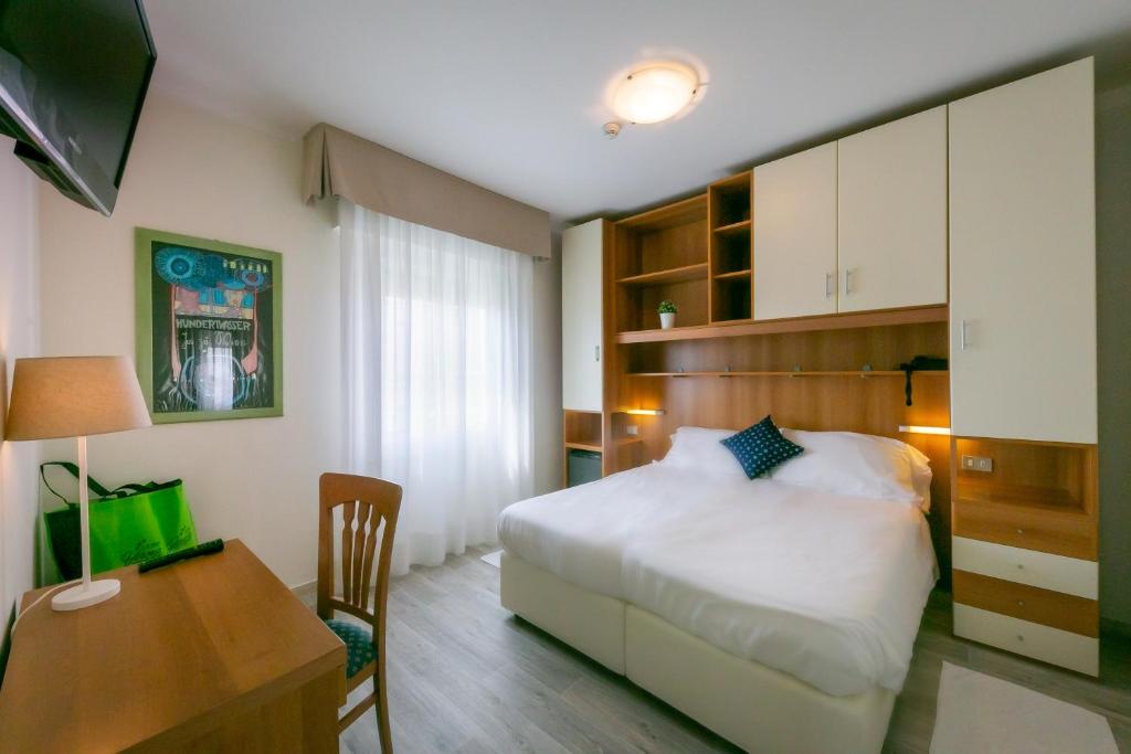 Postel nebo postele na pokoji v ubytování Hotel Verona