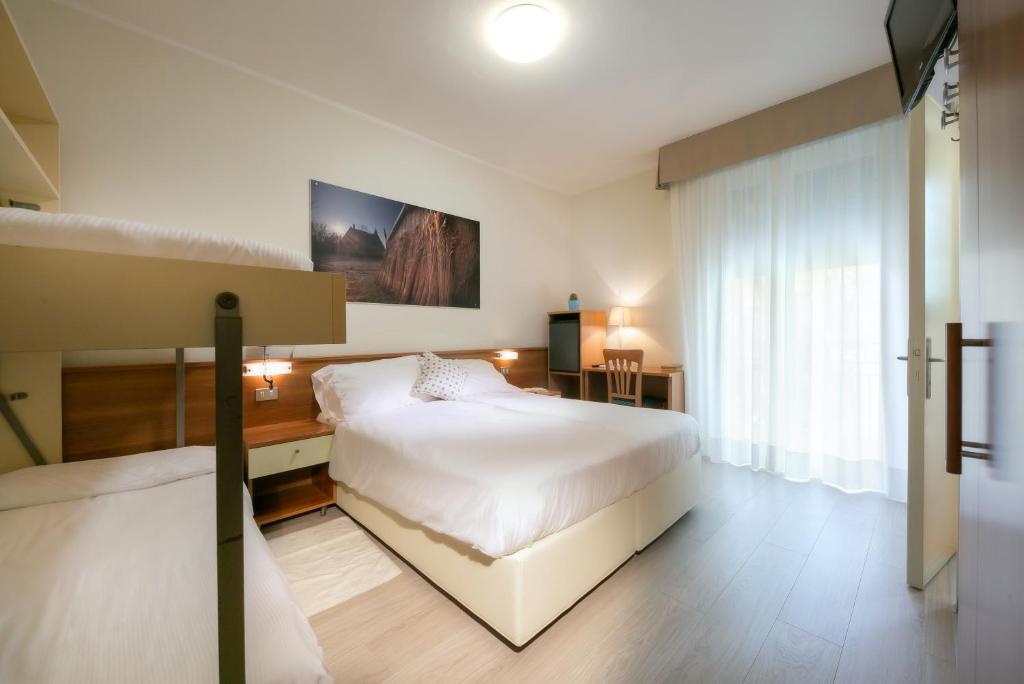 Postel nebo postele na pokoji v ubytování Hotel Verona