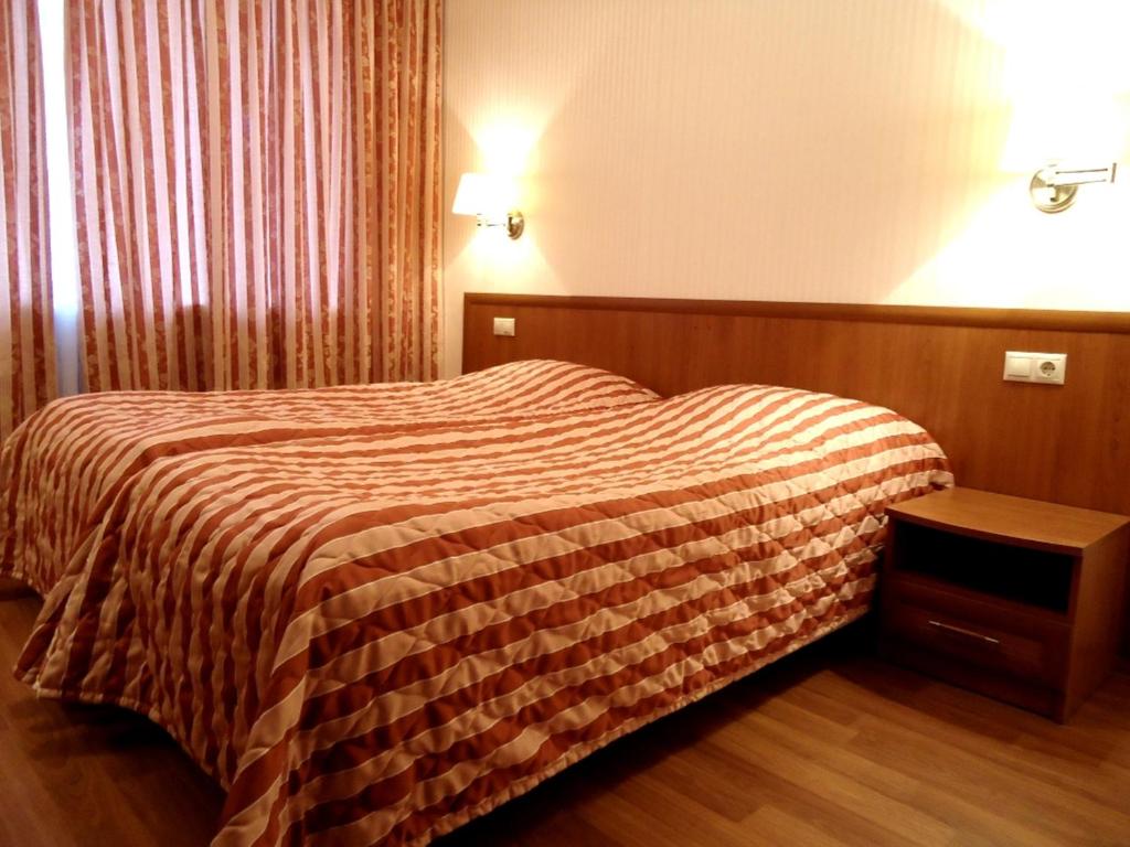 モスクワにあるApart-Hotel Kurkinoのベッドとテーブルが備わるホテルルームです。
