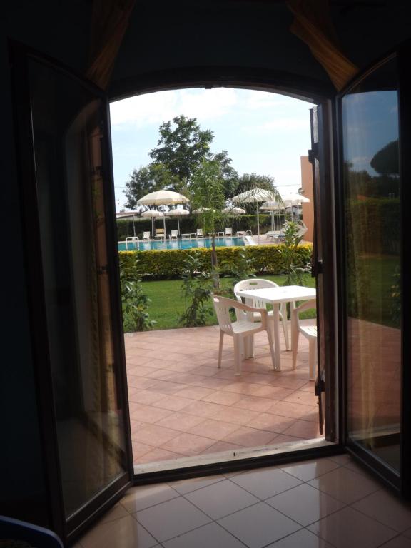 an open door to a patio with a table and chairs at Hotel Ristorante Al Canto delle Sirene in Terracina