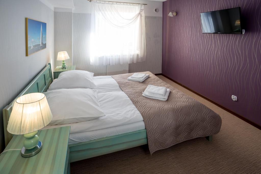 Postel nebo postele na pokoji v ubytování Kompleks Hotelowy Logos