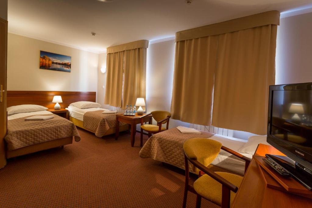 Postel nebo postele na pokoji v ubytování Kompleks Hotelowy Logos