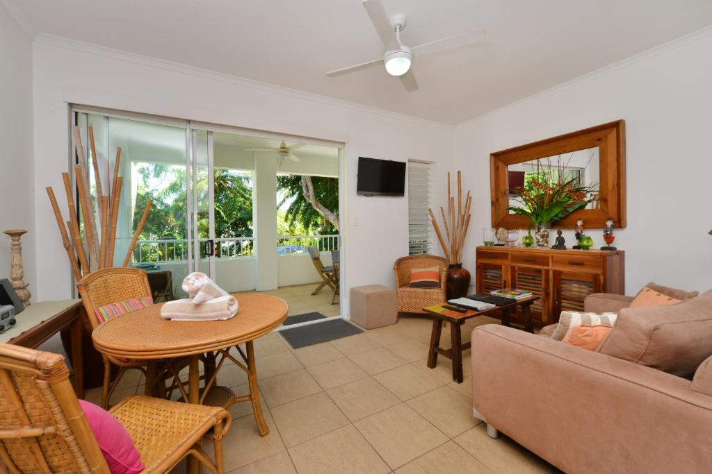 a living room with a couch and a table at Seascape Holidays at Portsea in Port Douglas