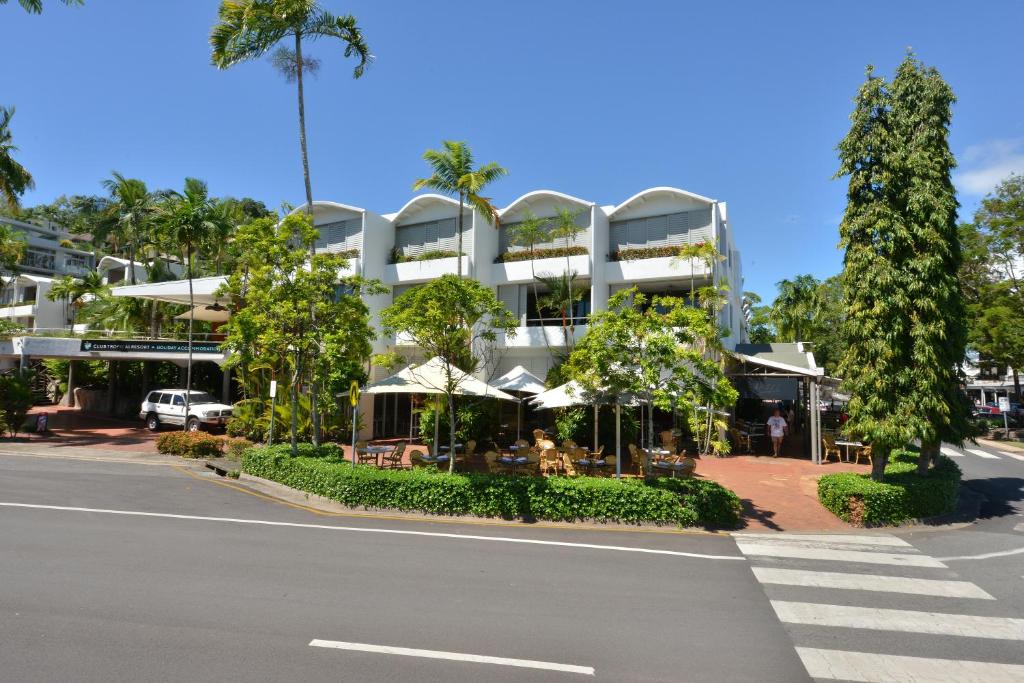 a large white building with trees and a street at Seascape Holidays at Club Tropical in Port Douglas