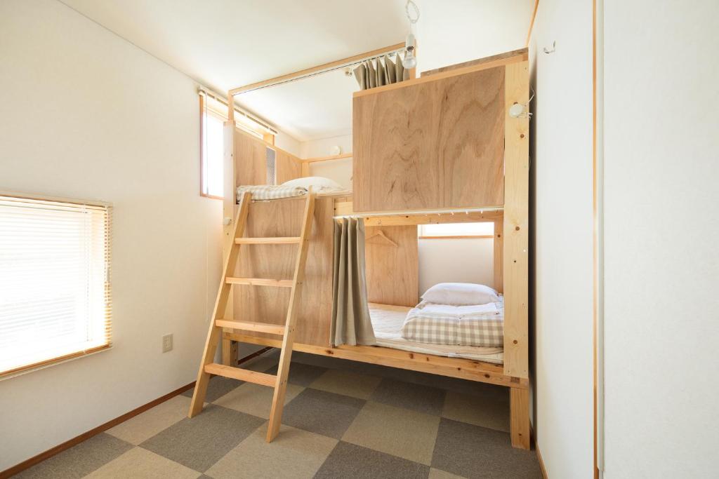 Postel nebo postele na pokoji v ubytování Sai no Tsuno Guest House