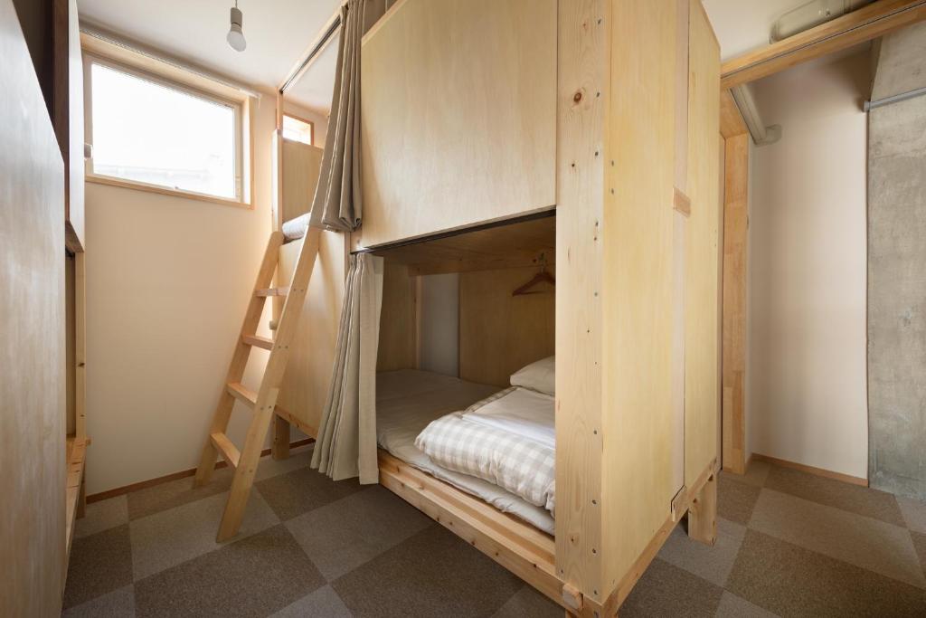 Postel nebo postele na pokoji v ubytování Sai no Tsuno Guest House