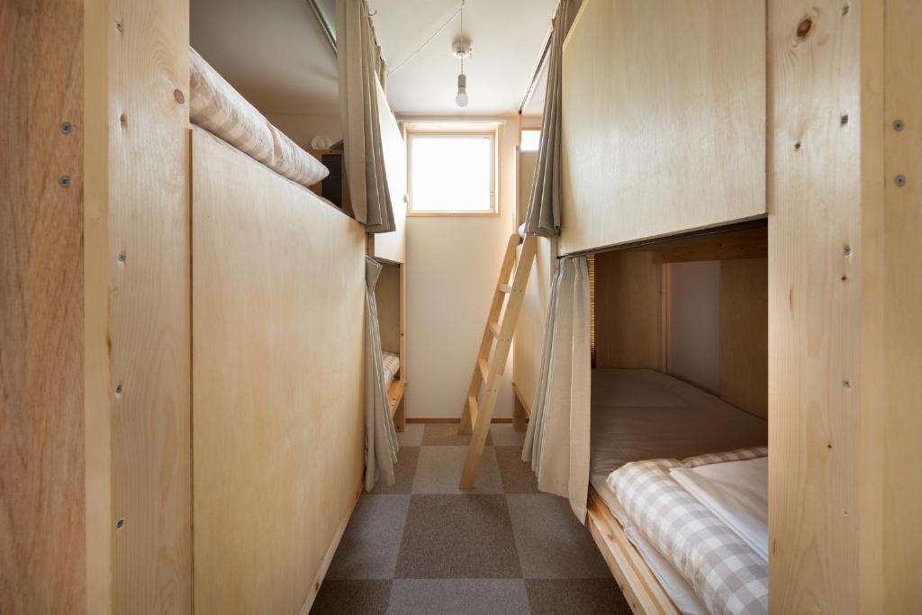 Postel nebo postele na pokoji v ubytování Sai no Tsuno Guest House