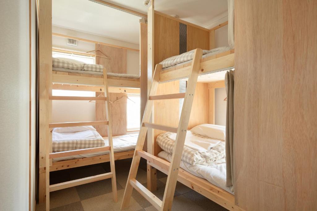 Postel nebo postele na pokoji v ubytování Sai no Tsuno Guest House
