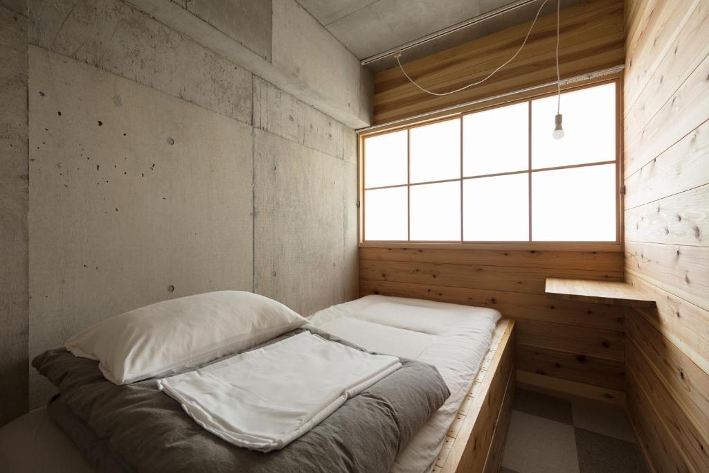 Postel nebo postele na pokoji v ubytování Sai no Tsuno Guest House