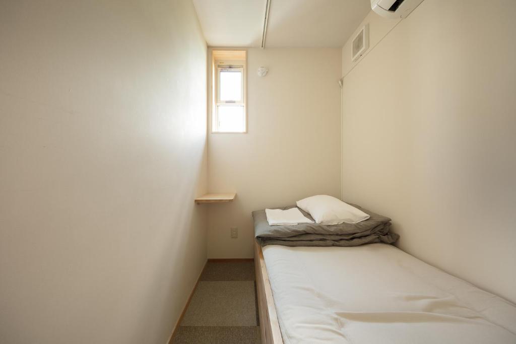 Postel nebo postele na pokoji v ubytování Sai no Tsuno Guest House