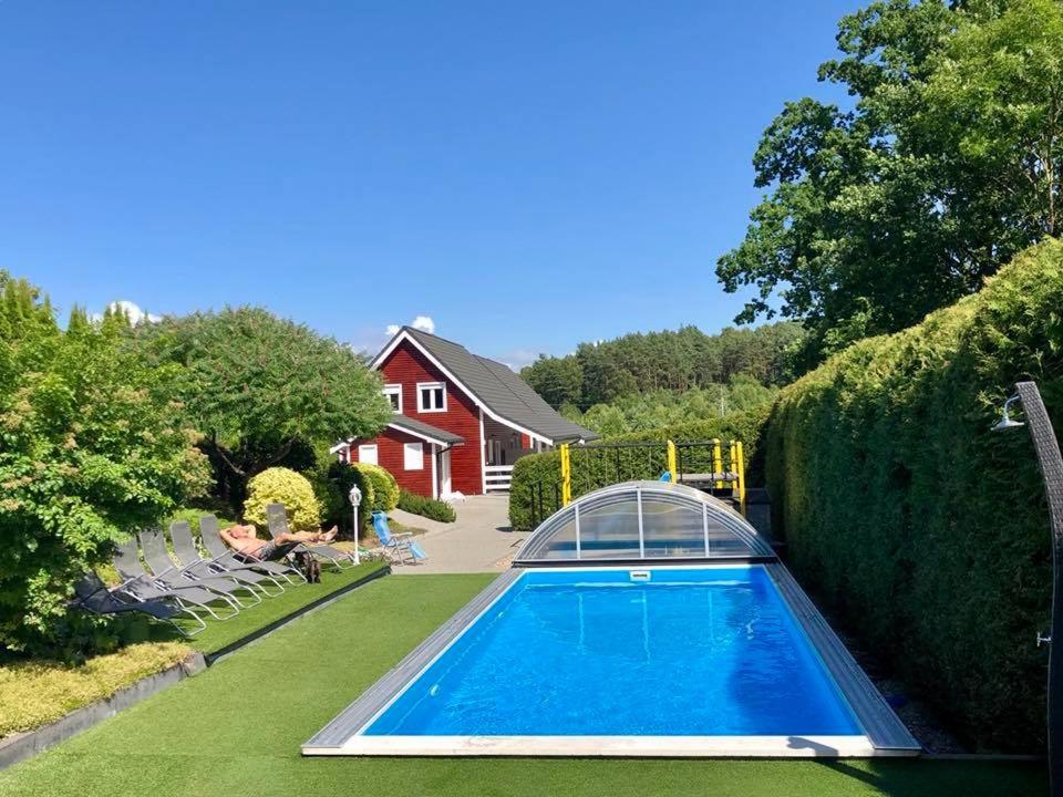 a swimming pool in the yard of a house at Apartamenty Beata Wisełka in Wisełka