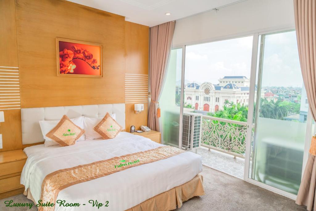 a hotel room with a bed and a large window at Palm Hotel Thanh Hoa in Thanh Hóa