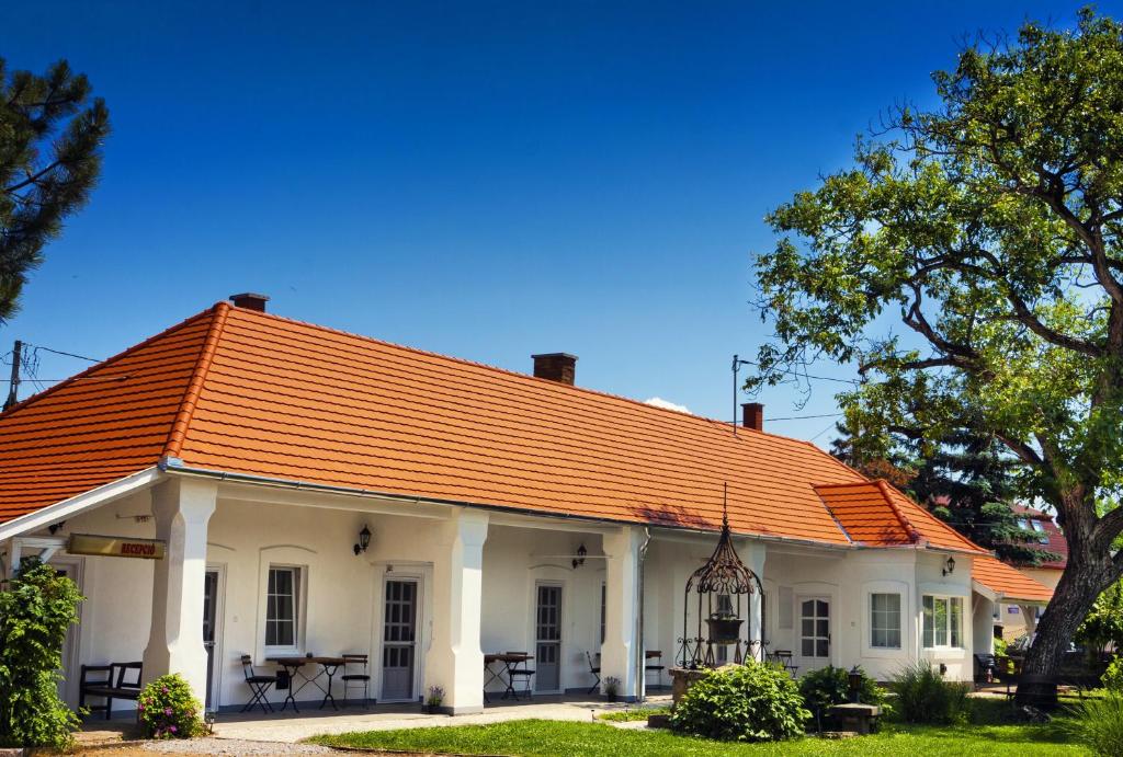 a white house with an orange roof at Öreg Malom Apartmanház in Bogács