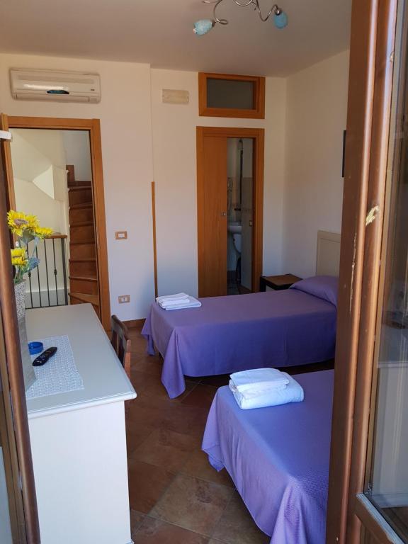 Postel nebo postele na pokoji v ubytování Locanda Aria del Re