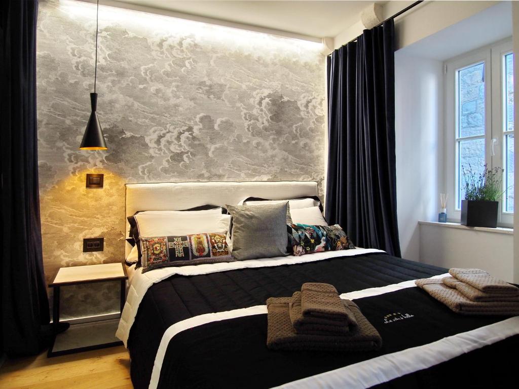 a bedroom with a large bed with a large wall at La Vita e Bella II in Dubrovnik