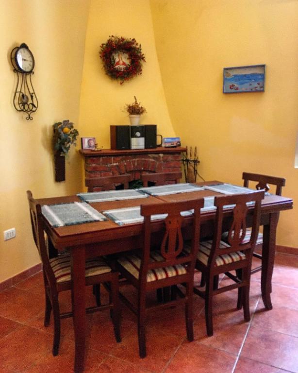 a dining room with a wooden table and chairs at Scalea Historic Center Apartments in Scalea
