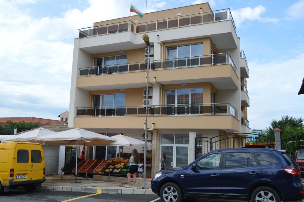 a blue car parked in front of a building at SummerHouse Lozenets in Lozenets