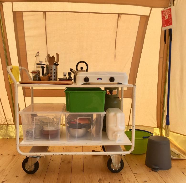 a kitchen cart with a stove and other items on it at VierVaart Tent in Groede