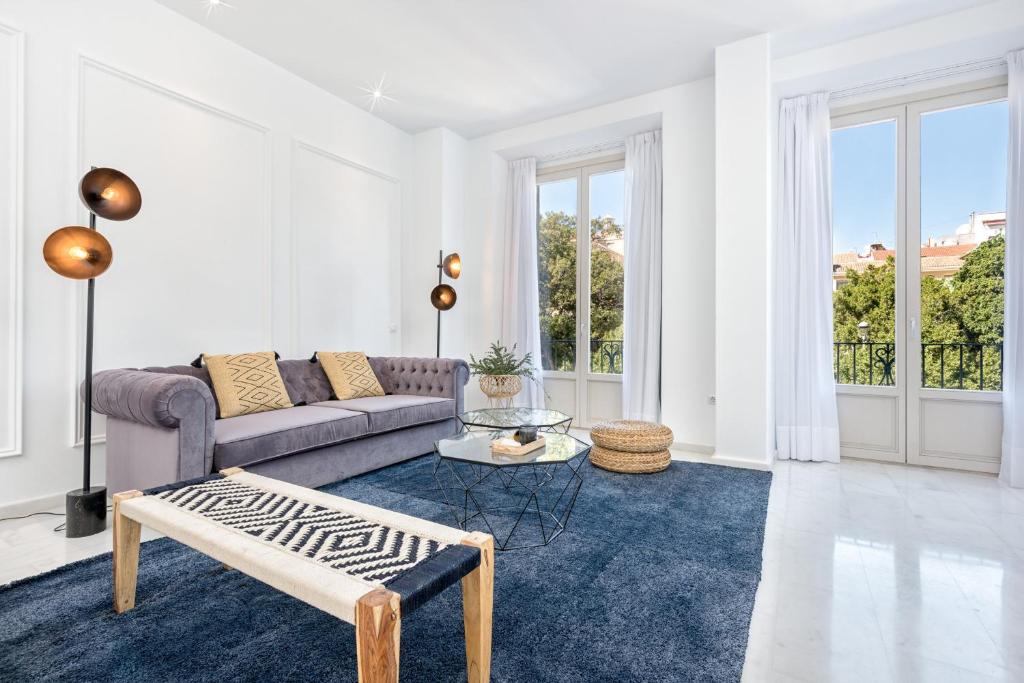 a living room with a couch and a table at iloftmalaga Premium Alameda Principal in Málaga