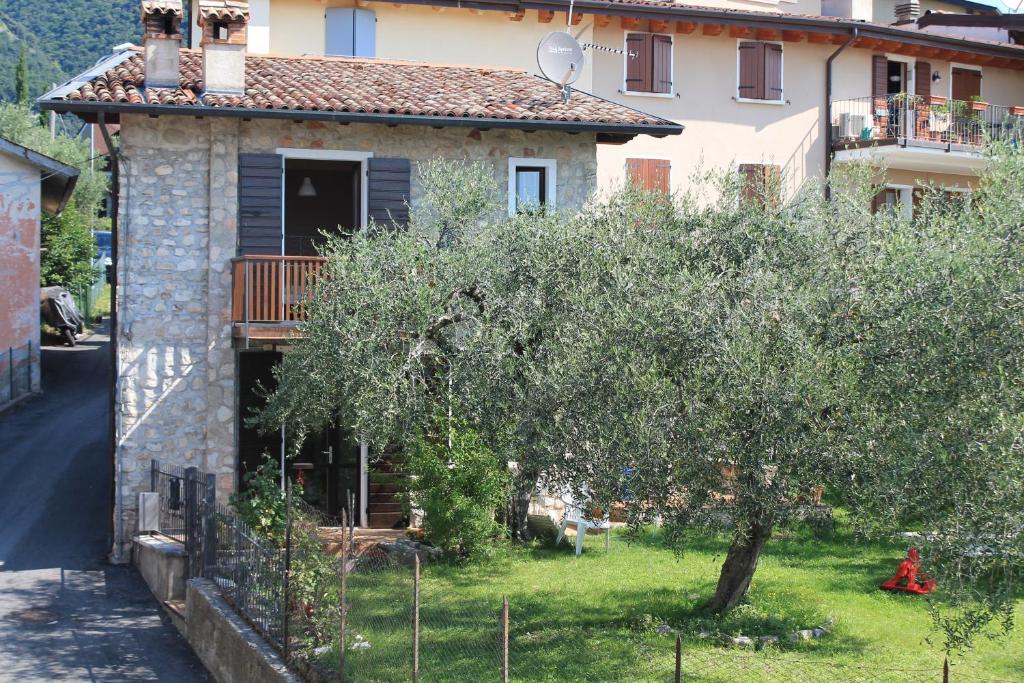a small house with a tree in front of it at Casa Andreina in Toscolano Maderno