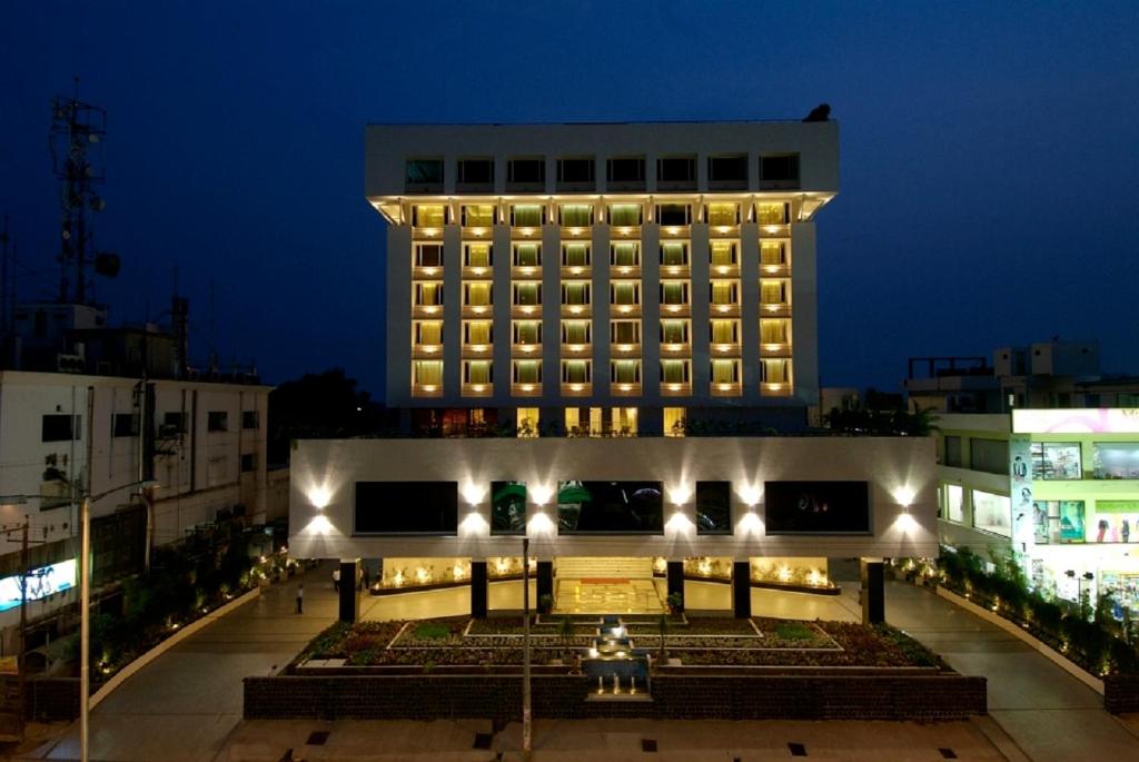 a large building with lights in front of it at Vivanta Vijayawada, MG Road in Vijayawāda