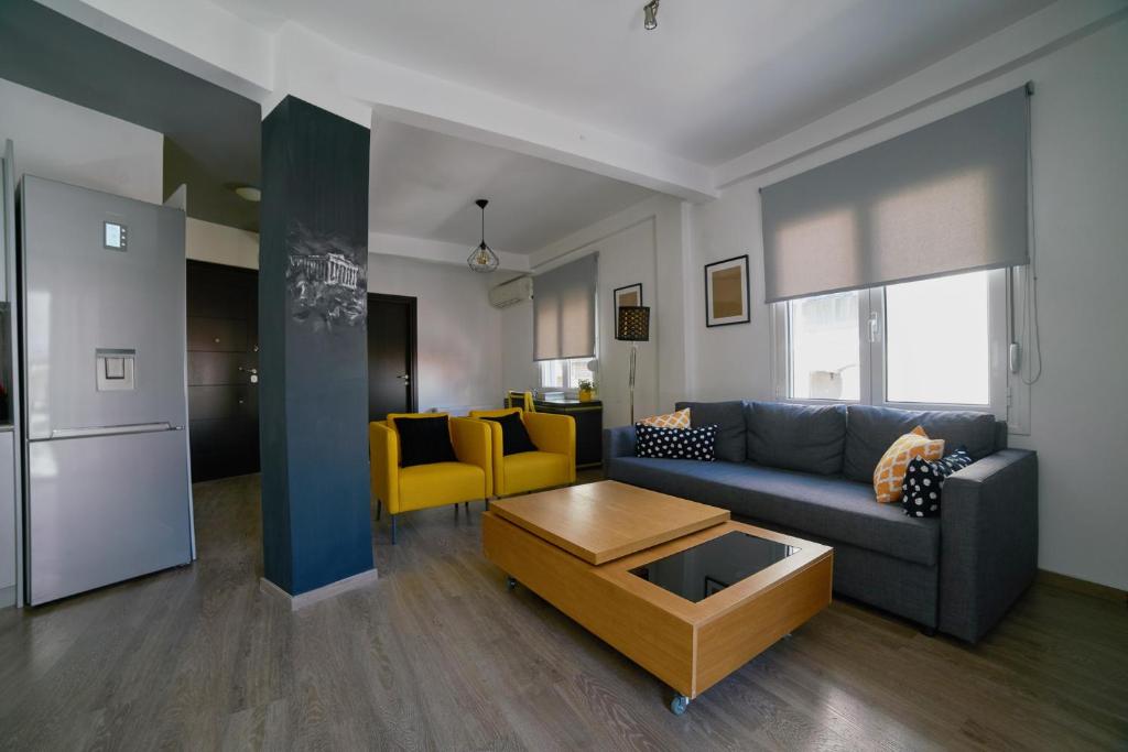 a living room with a couch and a table at V&V Central & Elegant Apartment in Athens