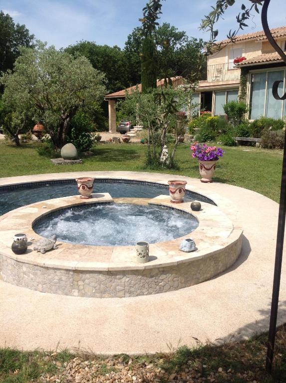 - une petite piscine avec une fontaine dans la cour dans l'établissement le lutin sur le toit, à Mazan