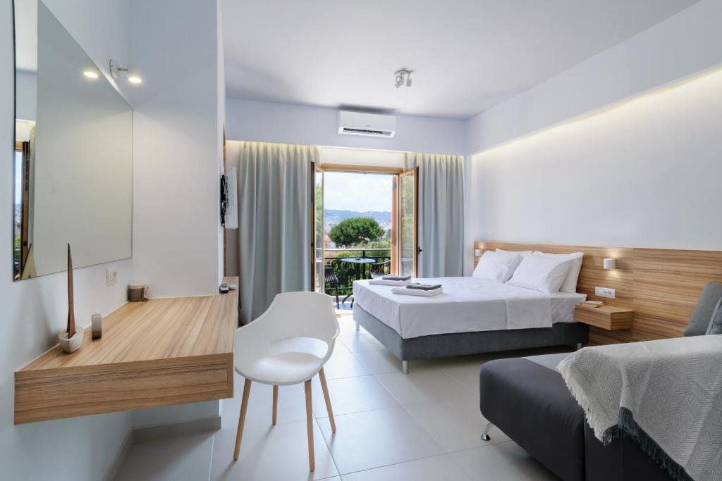 a hotel room with a large bed and a large window at Notus in Chania Town