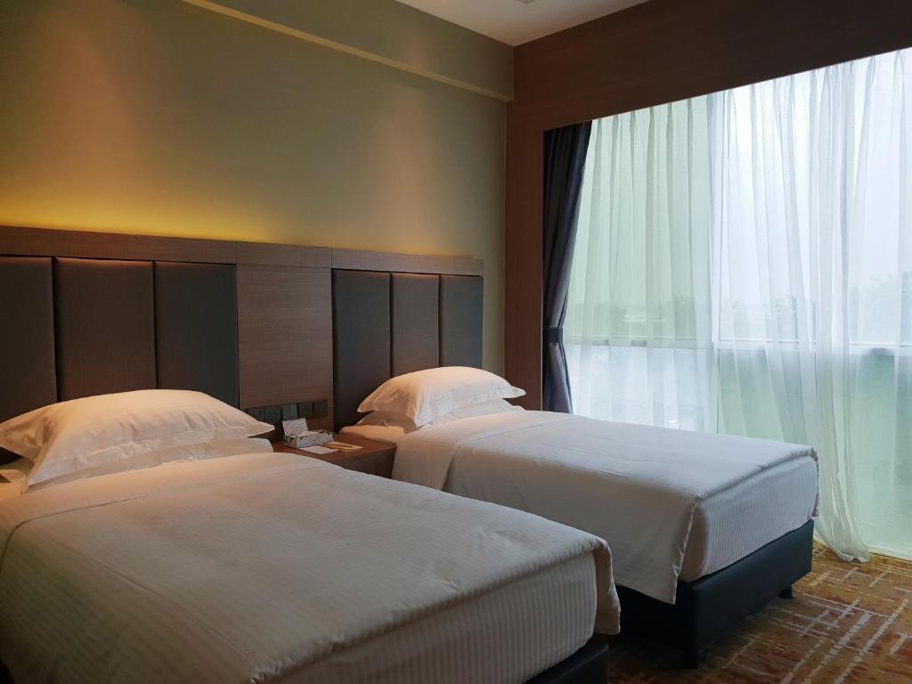 Postel nebo postele na pokoji v ubytování KSL Hot Spring Resort