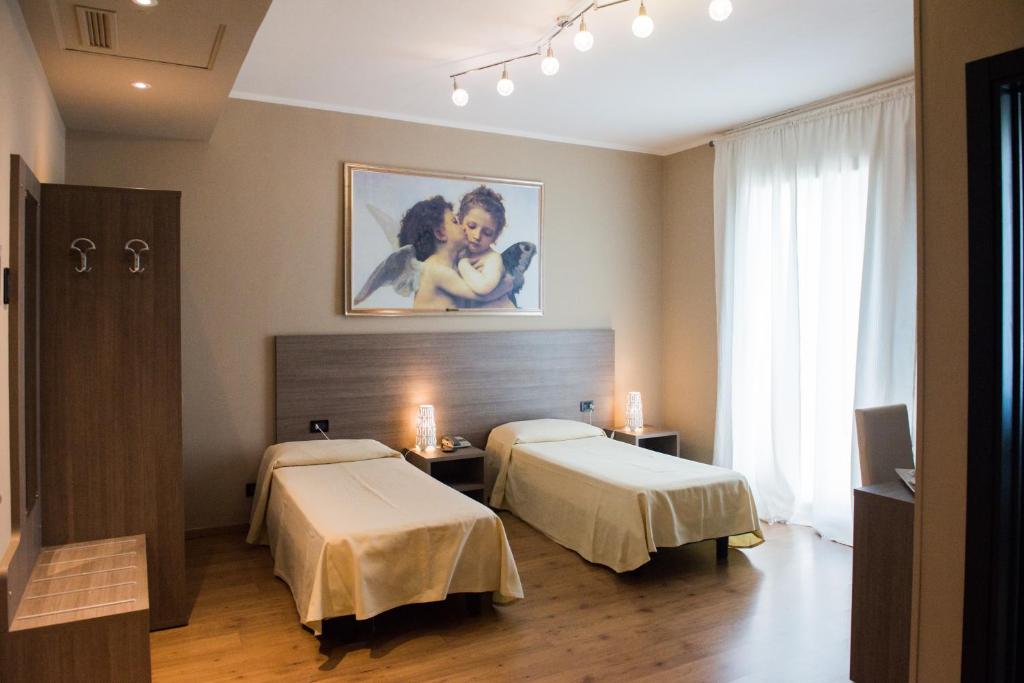 Postel nebo postele na pokoji v ubytování Albergo Grappolo D'oro