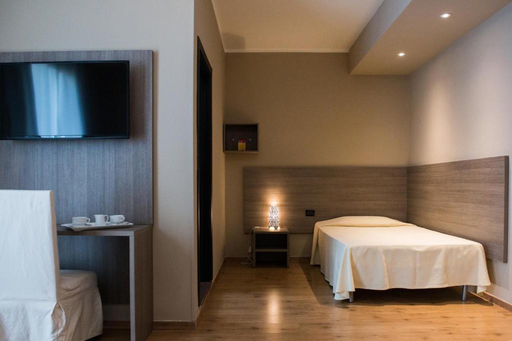 Postel nebo postele na pokoji v ubytování Albergo Grappolo D'oro
