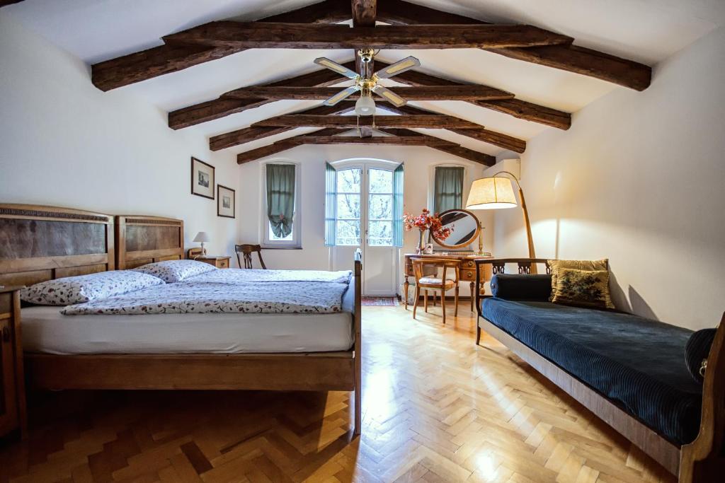 a bedroom with two beds and a ceiling with beams at Villa Fausta B&B in Trieste