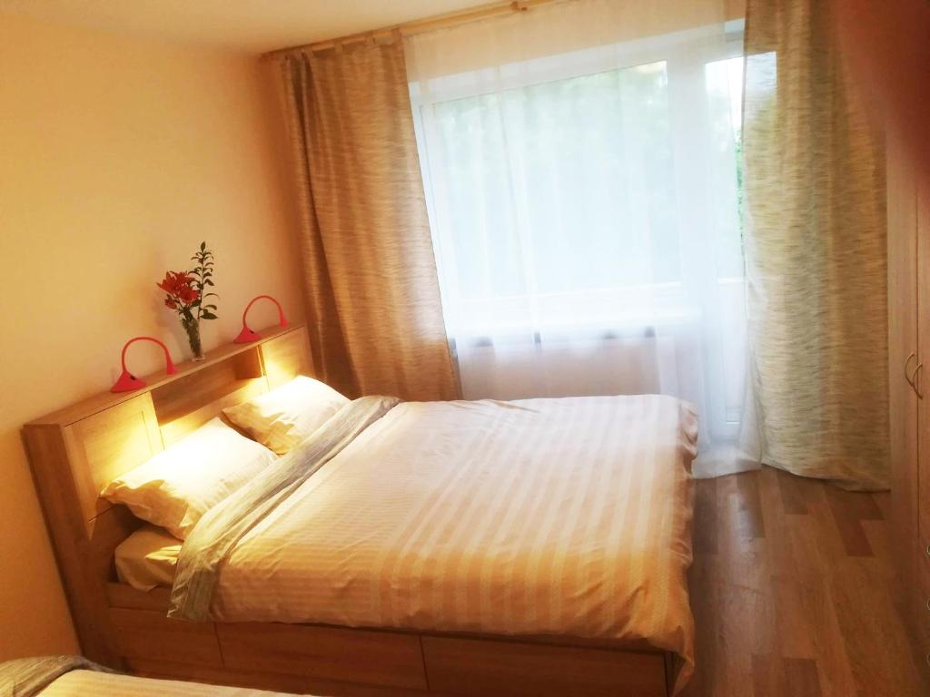 a bedroom with a large bed with a window at Couple getaway to a freshly renovated apartment in Pärnu