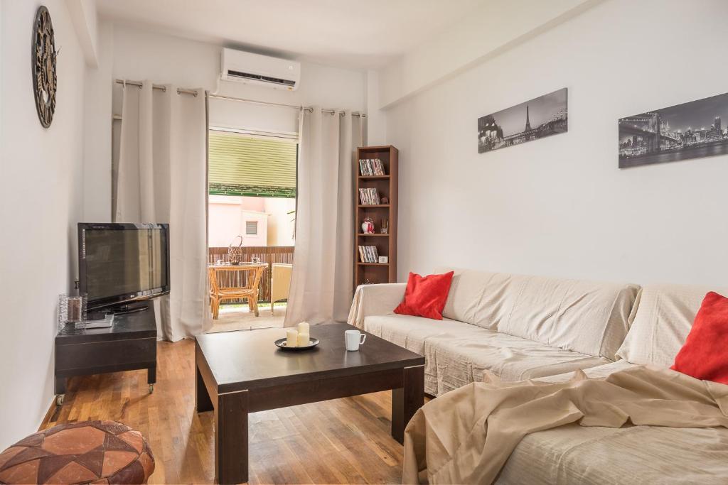 a living room with a couch and a coffee table at Alsos Family Apartment in Corfu
