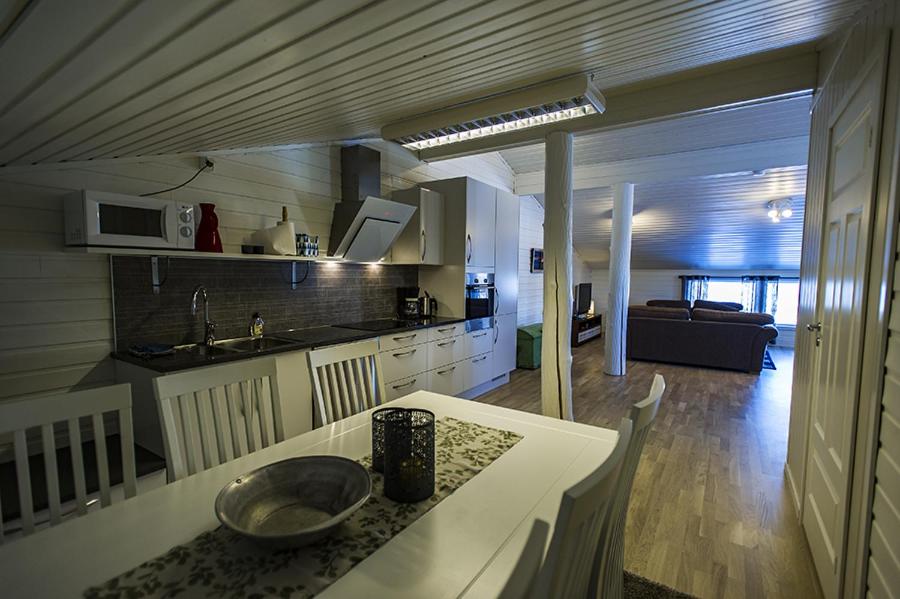 a kitchen and living room with a bowl on a counter at Malangen Apartment in Kjerkevik