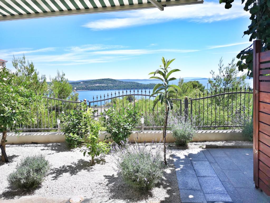 a garden with a view of the water at Villa Panorama Seget in Trogir