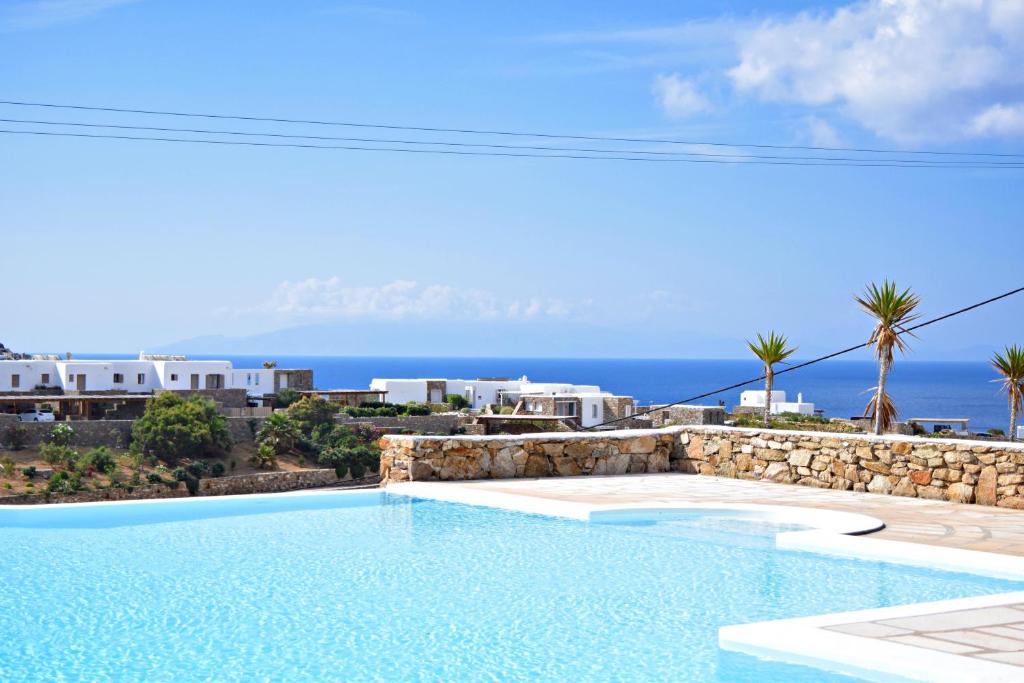 a swimming pool with a view of the ocean at Cavo Blue Villas in Elia Beach