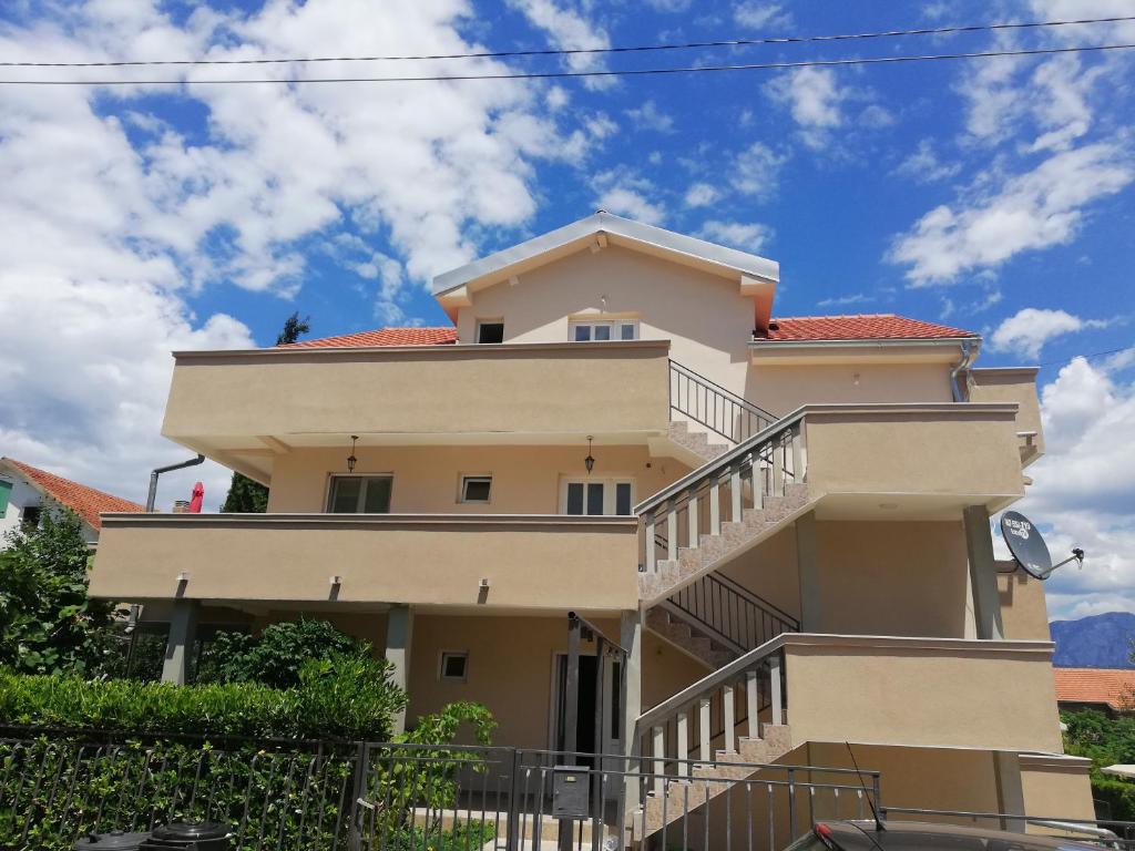 a building with stairs on the side of it at Apartmani Beljkas in Tivat